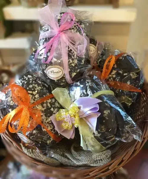 Wrapped colomba cakes with ribbons in a pastry shop